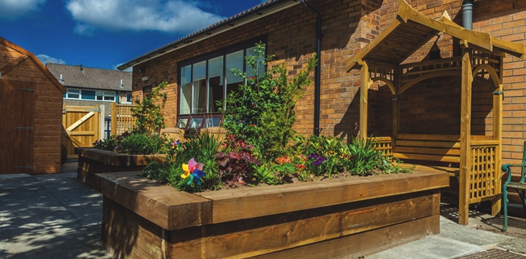 Exterior of Sunnyside Care Home with plants